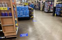 Stickers on the floor of a Kroger in Bloomington, Indiana, show how far apart customers should stand in checkout lines.