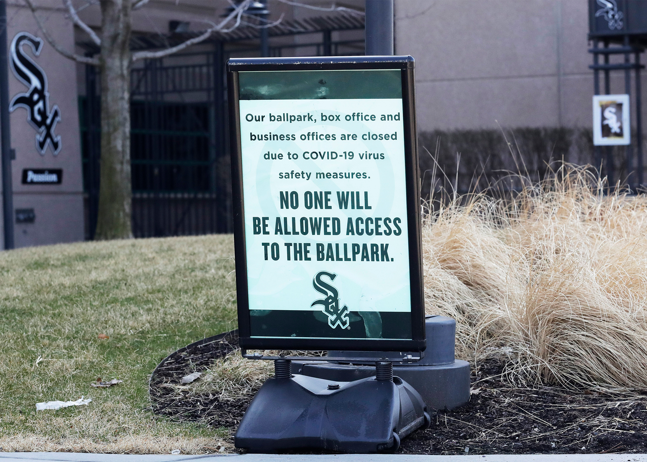 A sign stands in front of the Guaranteed Rate Field, home of the Chicago White Sox in Chicago, Wednesday, March 25, 2020. There will be empty ballparks on what was supposed to be Major League Baseball's opening day. The start of the regular season is indefinitely on hold because of the coronavirus pandemic.