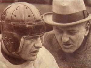 Red Grange talking with a football coach