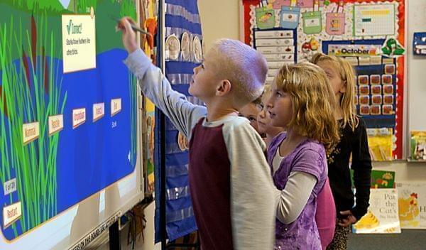 Students in Gibson City use a white board to play a learning game.