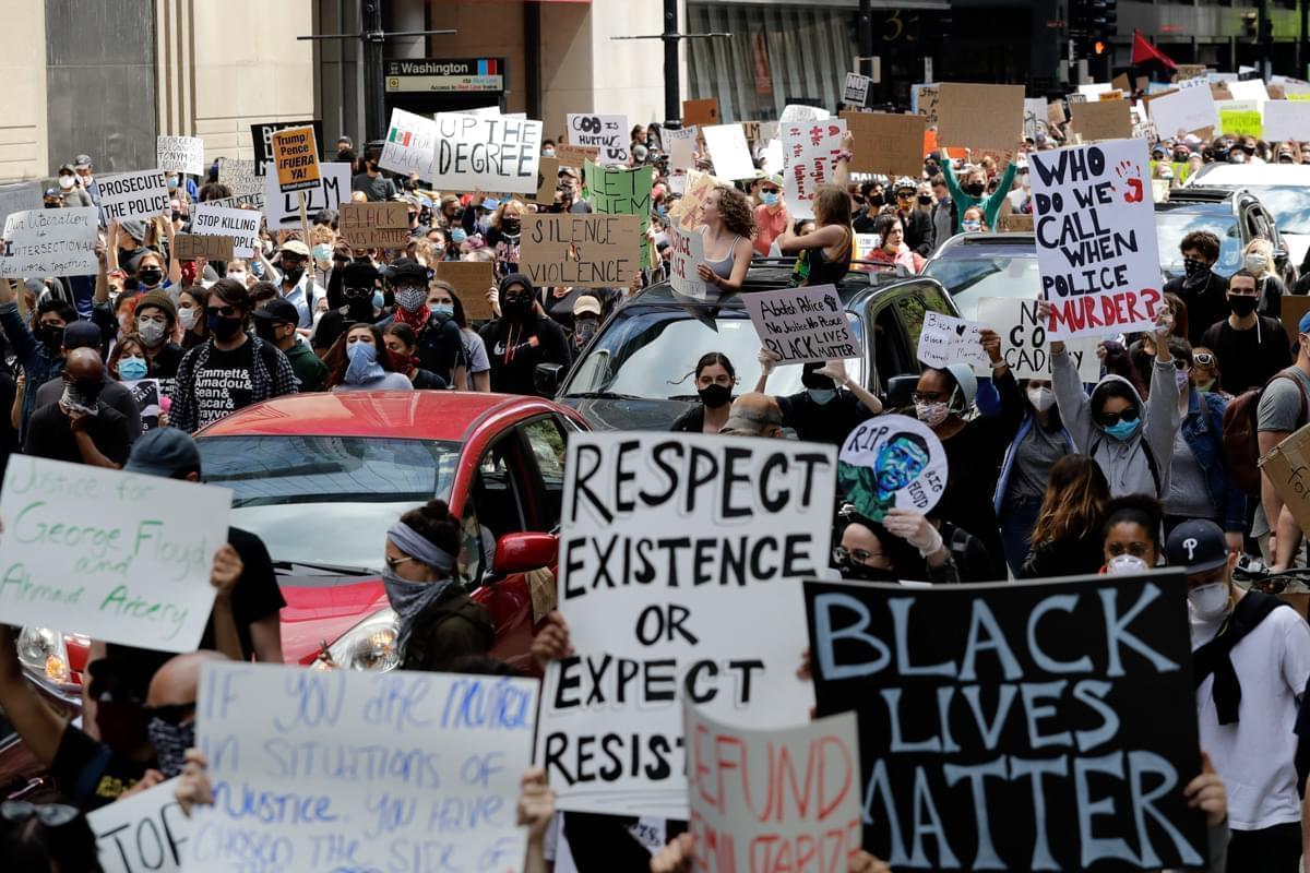 People confront police officers during a protest over the death of George Floyd in Chicago, Saturday, May 30, 2020.