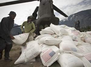 Pakistani aid workers offload USAID food supplies from an Army helicopter in Kallam Valley during catastrophic flooding in 2010.