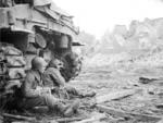 Soldier sitting by a tank
