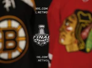 The 2013 NHL Stanley Cup logo is seen between the sweaters of the Boston Bruins and Chicago Blackhawks.