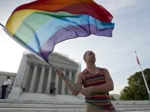 Gay rights advocate Vin Testa waving a rainbow flag in front of the U.S. Supreme Court building