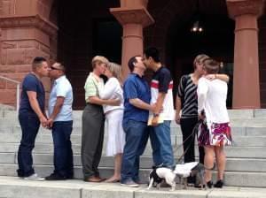 Couples kiss at the Old Orange County Courthouse in Santa Ana, California 