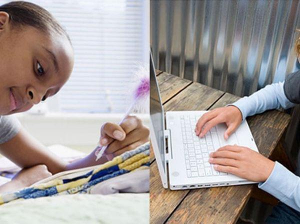 Girl reading and boy using laptop computer