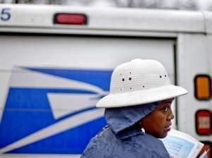U.S. Postal Service letter carrier Jamesa Euler delivers mail in the rain in Atlanta in February.