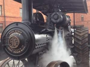 Evan Peach backs the steam engine into place on Friday morning in downtown Urbana.