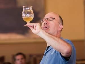 Ray Daniels inspects a glass of beer. A Chicago brewer, Daniels started the Cicerone training program five years ago.