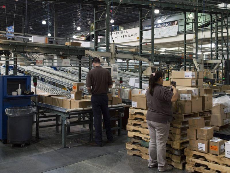 Workers prepare orders to be loaded for shipment at a UPS Healthcare Supply Chain and Distribution Center in Atlanta on March 12. The company recently announced that it would no longer offer coverage for spouses who had their own job-based insurance.