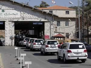 A convoy of inspectors from the Organization for the Prohibition of Chemical Weapons crosses into Syria at the Lebanese border crossing point of Masnaa on Tuesday.