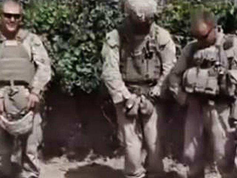 A still frame taken from a YouTube video shows Marines who were later disciplined for desecrating three dead Taliban members in a 2011 incident in the southern Afghan province of Helmand.
