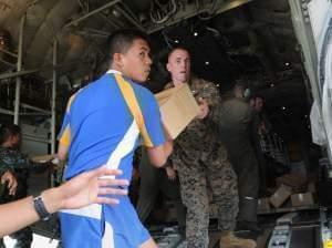 Military personnel from the U.S. and the Philippines unload relief goods at the Tacloban airport, Nov. 11, 2013. Some reports estimate that 10,000 people may have died in the city of Tacloban.