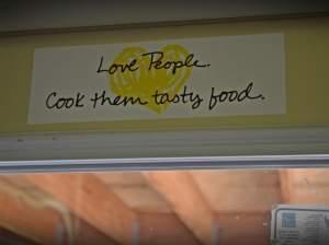 A sticker that reads "Love People. Cook them tasty food."