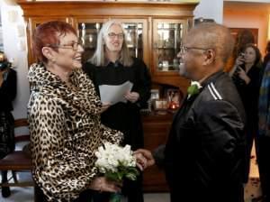 Patricia Ewert, left, and Vernita Gray, right, stand before Cook County Judge Patricia Logue, center, as she presides over their wedding ceremony, the first same-sex marriage in Illinois, at the couple's home Wednesday, Nov. 27, 2013, in Chicago