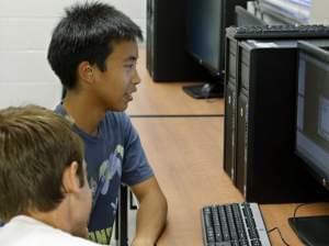 Alex Tu, left, an Advanced Placement student, works during a computer science class in Midwest City, Okla. There's been a sharp decline in the number of computer science classes offered in U.S. secondary schools.