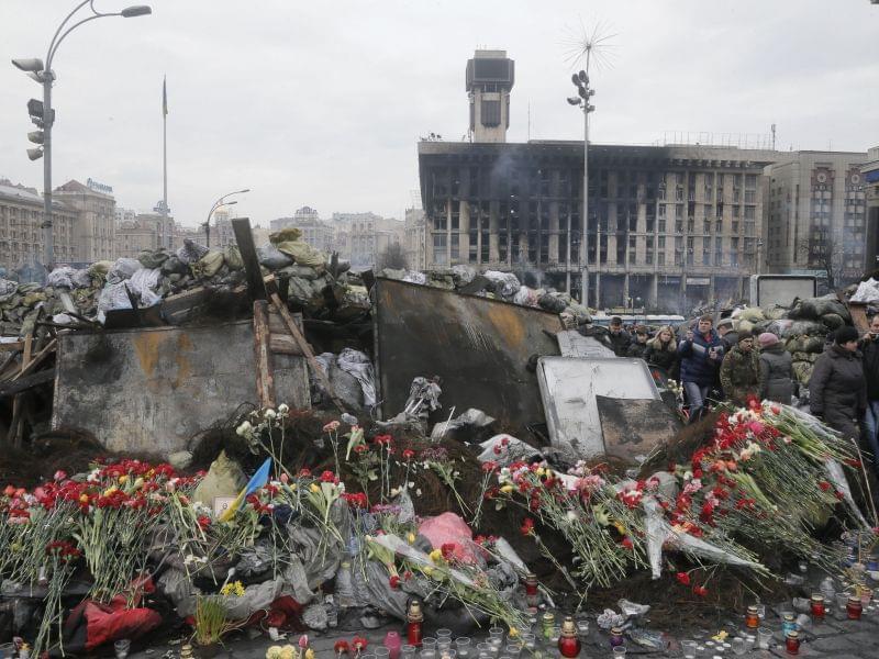 Flowers cover one of the barricades heading to Kiev's Independence Square, the epicenter of the country's recent unrest on a mourning day, Ukraine, Monday, Feb. 3, 2014. Official reports say 82 people were killed in severe clashes between o