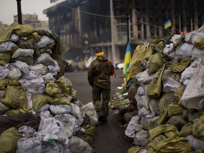 An anti-Yanukovych protester walks past a barricade in Independence Square, the epicenter of the country's current unrest, in Kiev, Ukraine, on Wednesday.
