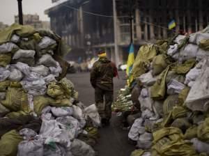 An anti-Yanukovych protester walks past a barricade in Independence Square, the epicenter of the country's current unrest, in Kiev, Ukraine, on Wednesday.