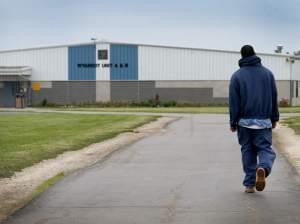 An inmate walks through the yard at the North Central Correctional Institution in Marion, Ohio, which recently switched to private management.