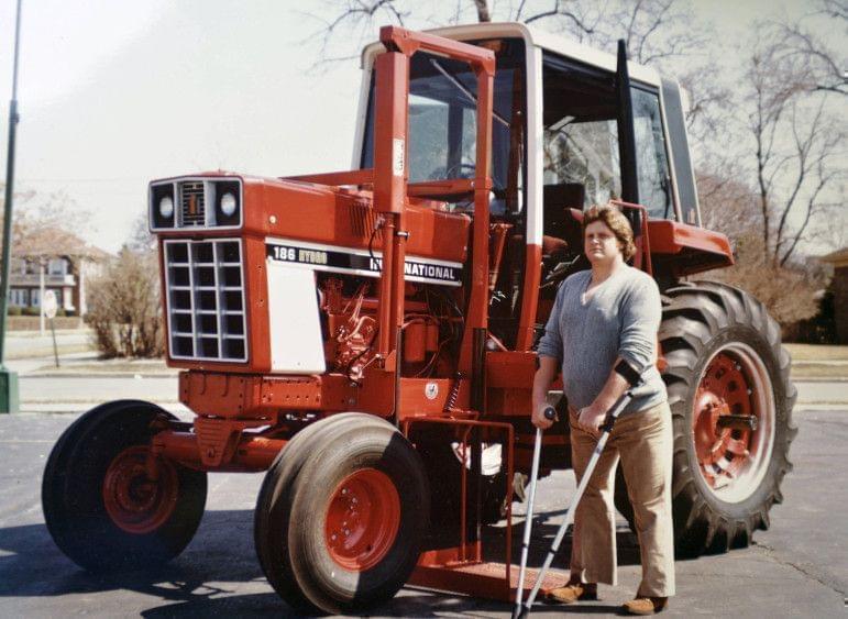 Chip Petrea stands near a modified tractor after his accident.