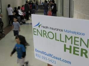 People wait in hallways for help enrolling in insurance at a city service center in southwest Houston on Monday.