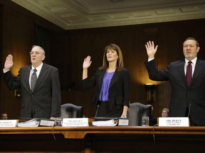 Caterpillar Inc Vice President for Finance Services Julie Lagacy is flanked by former Senior International Tax Manager Rodney Perkins (left) and Chief Tax Officer Robin Beran (right) as they are sworn in to testify on Tuesday.