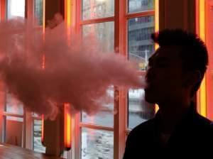 In this Feb. 20, 2014 photo, a patron exhales vapor from an e-cigarette at the Henley Vaporium in New York. The proprietors are peddling e-cigarettes to "vapers" in a growing movement that now includes celebrity fans and YouTube gurus, onli