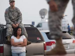 Lucy Hamlin and her husband, Spc. Timothy Hamlin, wait for permission to re-enter the Fort Hood military post, following a shooting there Wednesday.
