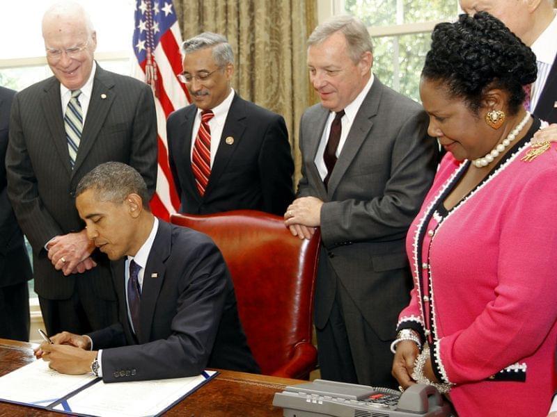 President Obama signs the Fair Sentencing Act in 2010, as Attorney General Eric Holder and a bipartisan group of senators look on.