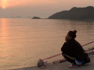 As the sun set Wednesday in Jindo, South Korea, a woman kept watch on the waters where the Sewol ferry sank. It's feared the death toll will reach 300.