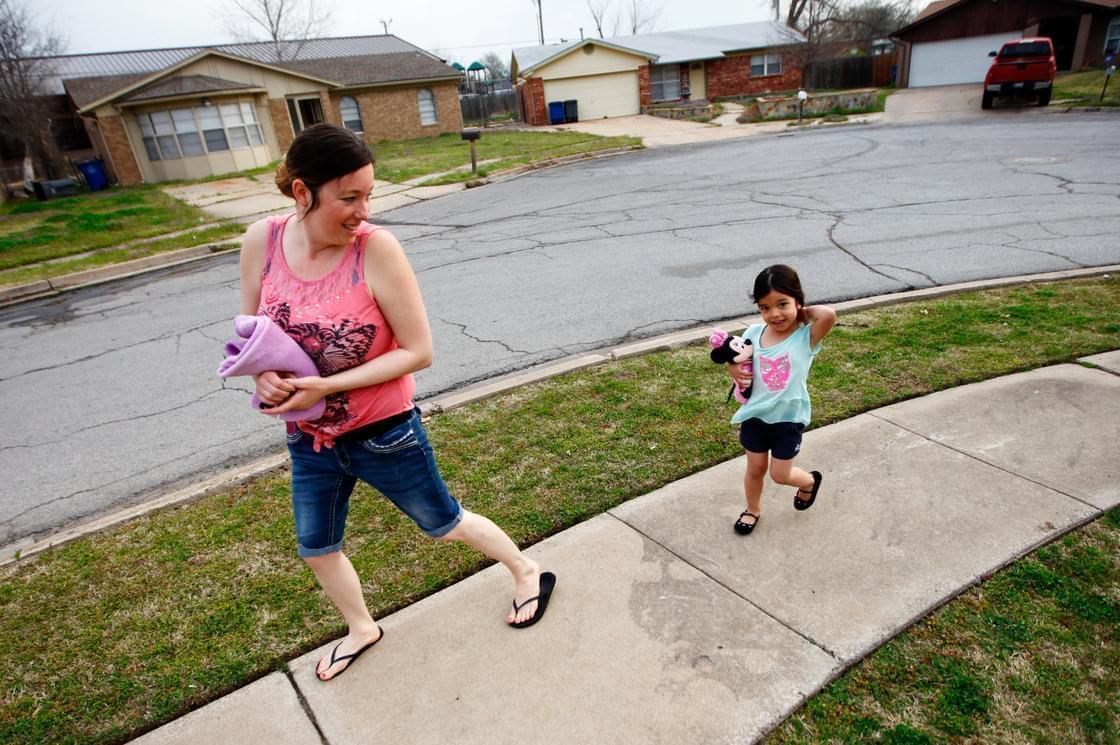 Tiffany Contreras walks her daughter Kyndall, 4, to preschool at Disney Elementary in Tulsa, Okla.