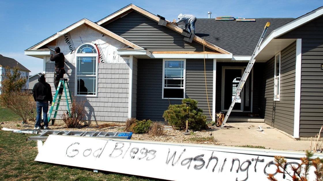 Washington, Ill., is full of both optimistic signs and lots of construction crews as the town rebuilds after a half-mile-wide tornado devastated the area last November.