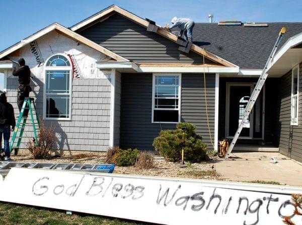 Washington, Ill., is full of both optimistic signs and lots of construction crews as the town rebuilds after a half-mile-wide tornado devastated the area last November.