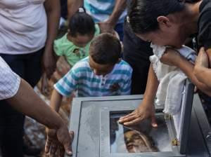 Loved ones express their grief at the burial of Ramon Romero Ramirez in Chichigalpa, Nicaragua, January 2013. The 36-year-old died of chronic kidney disease after working in the sugar cane fields for 12 years. Ramirez is part of a steady procession o