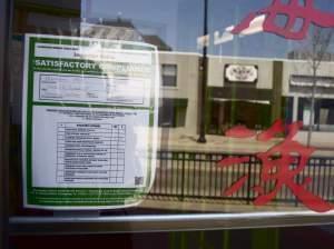 Mandarin Wok's satisfactory compliance placard, 403 1/2 E. Green St., Champaign on Friday, April 25. The restaurant failed its health inspection on March 24 with an adjusted score of 24 and four critical violations but was allowed to correct eno