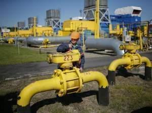 A worker turns a valve at an underground gas storage facility near Striy on Wednesday. Russia has said state-controlled exporter Gazprom will supply China with natural gas via a Siberian pipeline beginning in 2018.