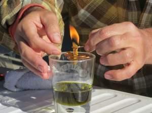 Derek Cross, a chef who specializes in cooking with hemp, demonstrates the burning properties of hemp oil, which he touts as a digestible bio fuel.