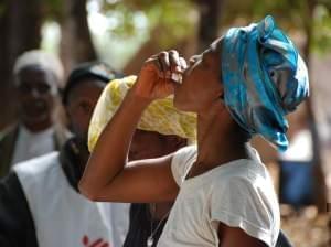 A woman in Guinea takes her first dose of the two-stage vaccine Shanchol during the country's 2012 epidemic.