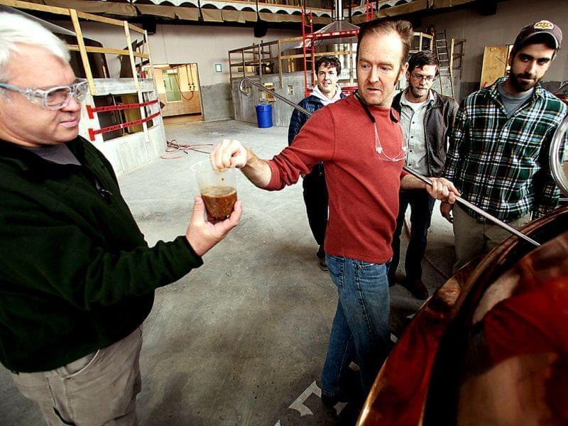 John Stuart (left) of Green Man Brewery grabs a Tater Ridge mash sample from Sierra Nevada's Scott Jennings (center) at the Sierra Nevada brewery in Mills River, N.C.