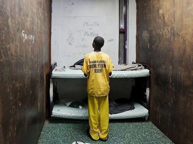 A male juvenile stands in a room at Harrison County Juvenile Detention Center in Biloxi, Miss.
