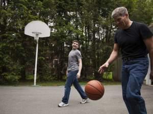 Ed Damiano and his son David, 15, play basketball at home in Acton, Mass. Ed has invented a device he hopes will make David's diabetes easier to manage.