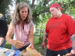 Farmer Kate Potter shows Chef Terrah King how to gut a chicken during Chef Camp on June 8, 2014 in Livingston County, Ill.