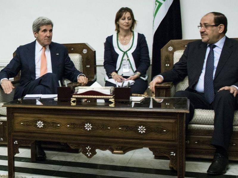 Iraqi Prime Minister Nouri al-Maliki (right) sits with Secretary of State John Kerry on Monday. Kerry was in Baghdad to push for Iraqi unity and stability, as Sunni militants swept through western towns abandoned by security forces.