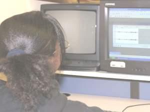 Honesty, a student at Edison Middle School, edits her radio story in the computer lab at school.