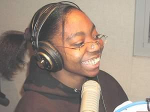 Honesty, a student at Edison Middle School, laughs in the radio studio 