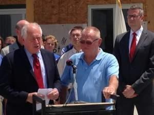 (l to r) Gov. Pat Quinn speaks during a press conference in Gifford, Ill. on July 7, 2014. Gifford village president Derald Ackerman and State Sen. Mike Freirchs (D-Champaign) stand beside him.