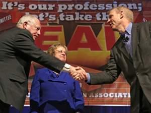 Illinois Gov. Pat Quinn, left, and his Republican rival, Bruce Rauner, shake hands after they appeared together for the first time before the 2014 general election, during the annual meeting of the Illinois Education Association Friday, April 11, 201
