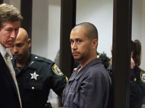 George Zimmerman, center, is directed by a Seminole County Deputy and his attorney Mark O'Mara during a court hearing Thursday April 12, 2012, in Sanford, Fla.